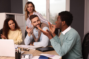 Canvas Print - Team of employees working together in office. Startup project