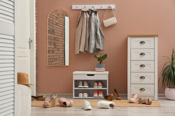 Canvas Print - Stylish furniture and scattered shoes on floor in hall