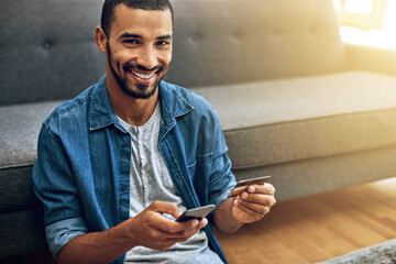 Aufkleber - I have no time to go stand in a line. Shot of a focused young man doing online banking with her phone while being seated on the floor next to a couch at home.