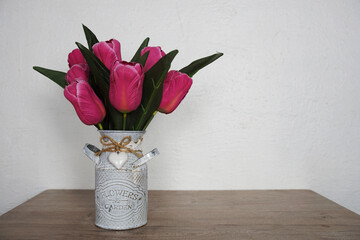 Canvas Print - Pink Tulip flowers bouquet in metal vase with space copy on wooden shelves