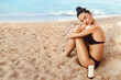 Young Woman in Bikini Applying Sun Cream on Tanned  Shoulder.