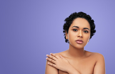 Wall Mural - beauty and people concept - portrait of young african american woman with bare shoulders over violet background