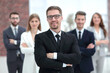 © ASDF - confident businessman in front of his business team.