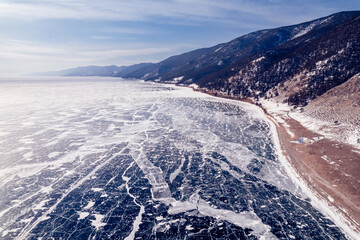Wall Mural - Beautiful winter landscape lake Baikal clear blue ice with cracks, aerial top view