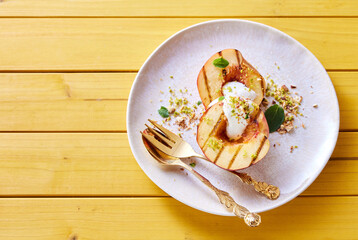 Wall Mural - Delicious grilled peaches with natural yogurt on plate