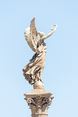 Wall Mural - Statue of beautiful angel with wings at sunset colors in Prague historical downtown, Czech Republic, closeup, details.