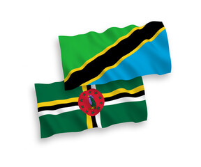 National vector fabric wave flags of Dominica and Tanzania isolated on white background. 1 to 2 proportion.