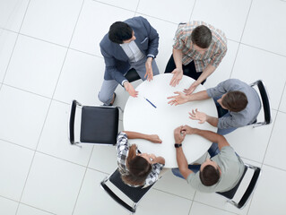 Wall Mural - top view.Manager and creative team sitting at the round table