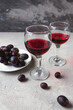 © Дмитрий  - two glasses with red wine and grapes on a concrete background