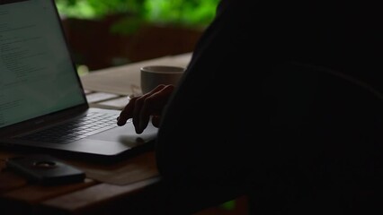 Outside office. Man uses touchpad to scroll through information on laptop. Work online. Freelance. Software. Programmer encodes. Creating sites. IT specialist