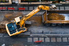 Construction Equipment Excavates A City Street To Improve The Wastewater Infrastructure. Top View. Selective Focus Machine