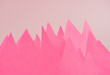 Mountains or market volatility creative minimal concept made of pink color sheet of paper on a light pastel background with copy space.
