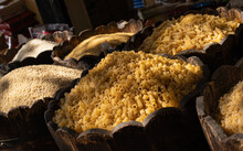 Assorted Pasta And Groats On The Market Counter. Wooden Bowls With Various Cereals At The Food Market. Dramatic Light