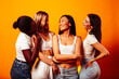 © iordani - diverse multi nation girls group, teenage friends company cheerful having fun, happy smiling, cute posing on yellow background, lifestyle people concept, african-american, asian and caucasian
