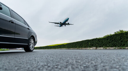 An airplane flying over the car