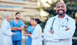 © C Coetzee/peopleimages.com - Theres nothing you cant fix with a smile. Shot of a mature male doctor standing with her arms crossed in the city.