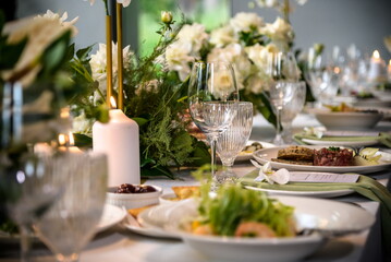 Wedding banquet. The festive table is served with plates with na