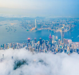 Wall Mural - Amazing aerial view of Victoria Harbour, Hong Kong, in a cloudy day