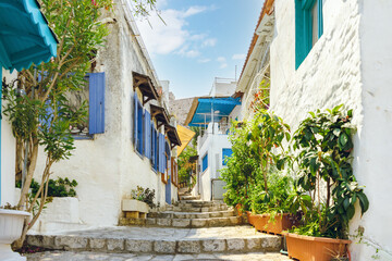 Narrow street in old town of Marmaris, Turkey . Beautiful scenic old ancient white houses with flowers. Popular tourist vacation destination