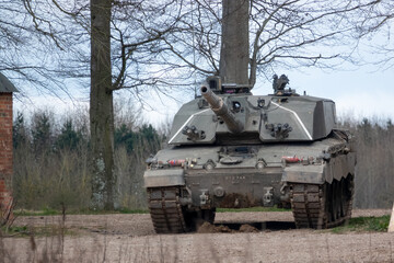 british army challenger 2 ii fv4034 main battle tank stationary between empty buildings, awaiting de