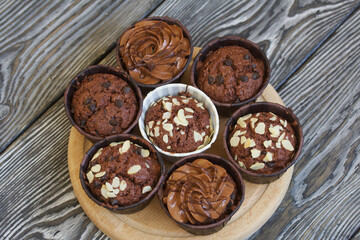 Wall Mural - Chocolate muffins with different fillings. On black pine boards. Shot close-up.