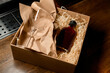 © fesenko - great view of a cardboard box with a transparent glass and a small bottle with an alcoholic drink