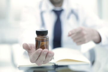 Wall Mural - Doctor showing drug or medicine bottle in clinic