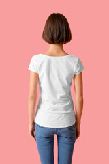 Wall Mural - Beautiful young woman in stylish t-shirt on color background, back view