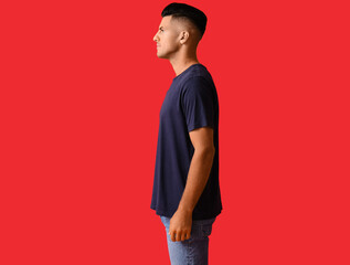 Poster - Handsome young man in stylish t-shirt on color background