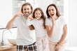 © Pixel-Shot - Happy family brushing teeth in bathroom