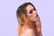 © Pixel-Shot - Fashionable young transgender woman with glitters on body against color background