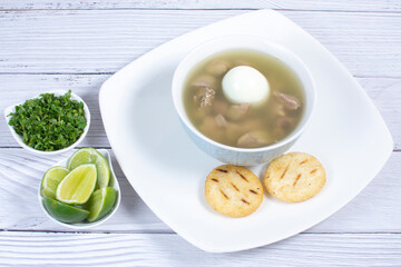 Sticker - Chicken consomme, traditional Colombian food, accompanied by hard-boiled egg, corn arepas, cilantro and lemon