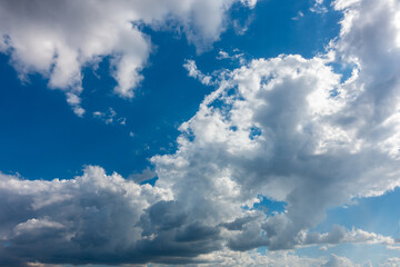 Wall Mural - blue sky and dark clouds.fluffy cloud in the blue sky background.vivid sky on dark cloud before summ
