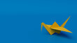 © RocknRoller Studios - Yellow Origami Bird. Minimalist Design with Blue Background and Copy Space.