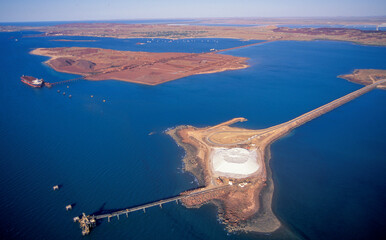 Sticker - Salt stock pile and iron ore stock pile  at Dampier on the Western Australia coast.