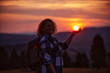 © Minet - A photo of a woman hiking at sunset time. Selective focus