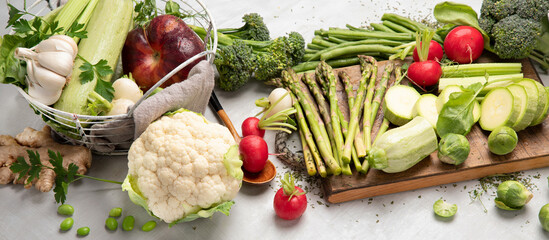 Wall Mural - Raw and fresh spring vegetables on light background.