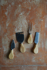 Wall Mural - a set of cheese knives on rusty marble texture for digital wall tiles and floor tiles, marble textur