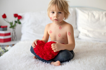 Sticker - Beautiful blond toddler child, boy with lipstick kisses on his body, holding red rose for Valentine