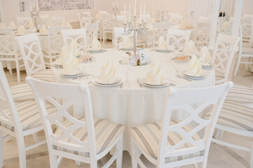 Close up arranged table with plates and glasses on a wedding