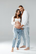 © Josep - Attractive pregnant woman in a studio with her handsome husband wearing bright shirts and laughing