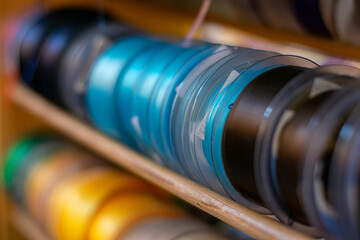 Wall Mural - Many colorful ribbons stacked on a shelf to be sold in store, ribbon sale in a shop, creative handcraft or sewing accessories in rolls. Selective focus with shallow depth of field.