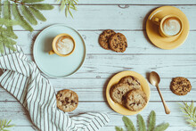 Overhead View Of Two Cups Of Coffee And Chocolate Chip Cookies On A Table