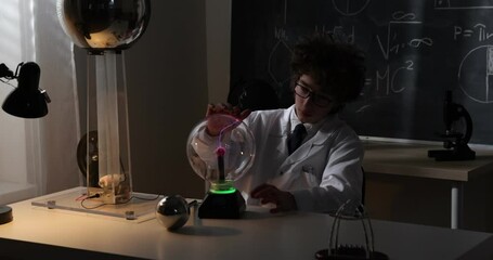 Wall Mural - schoolboy experimenting in physics class. young student doing physics experiment in the classroom