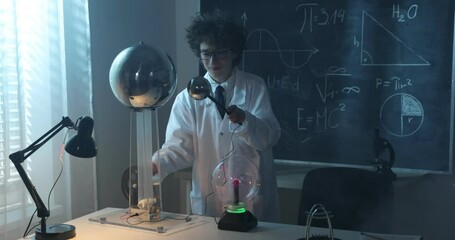 Wall Mural - a boy conducts physical experiments with electricity, a plasma ball, and a van de graaff generator.