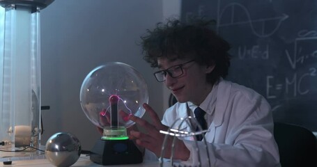 Wall Mural - schoolboy experimenting in physics class. young student doing physics experiment in the classroom.