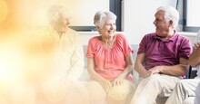 Blur Effect With Copy Space Against Group Of Senior People Smiling Together At Retirement Home