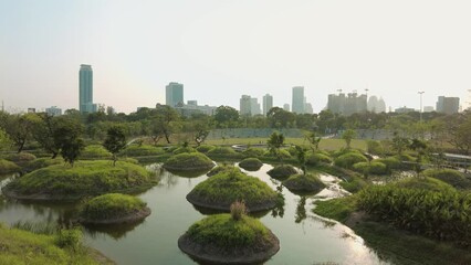 Wall Mural - The Benchakitti Park in Bangkok Thailand, public green park after a recent extension with extra greenery, water features and walkways built.