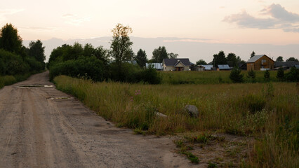 Wall Mural - Beautiful rustic summer landscape with road. Old wooden log houses. Vologda region