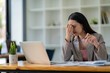 © crizzystudio - Tired young woman freelance worker rubbing her eyes while sitting in front of laptop computer and working on promising project